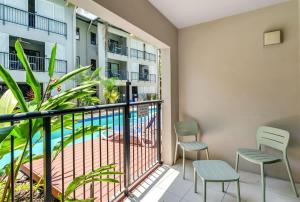 a balcony with chairs and a swimming pool at Laguna Edge - Swim-Out Studio, near Sea & Dining in Trinity Beach