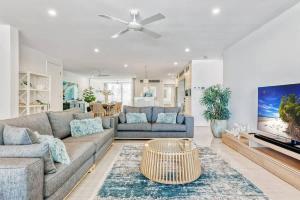 a living room with a couch and a table at Bougainvillea - Beachside Luxury at The Drift in Palm Cove +18 photos