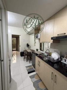 a kitchen with a counter and a dining room at Unit 208 Venus Transients-Brenthill in Baguio