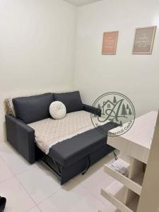 a black couch in a room with a table at Unit 208 Venus Transients-Brenthill in Baguio