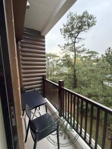 a balcony with a table and a chair on it at Unit 208 Venus Transients-Brenthill in Baguio