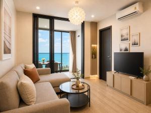 a living room with a couch and a television at The Edge central pattaya in Pattaya