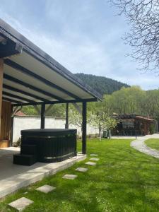 a pavilion in a park with a grass field at Pensiunea Cold Mountains in Râşnov