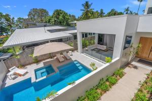 an aerial view of a house with a swimming pool at Salt - Beachfront Luxe with Private Pool in Palm Cove