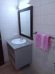 a bathroom with a sink and a mirror at Hotel Flamboyan Kuta in Kuta +22 photos