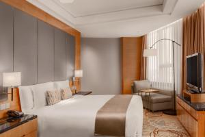 a hotel room with a bed and a television at Crowne Plaza Shanghai Anting, an IHG Hotel - 15 minutes drive to F1 in Jiading