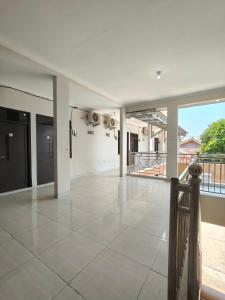 an empty living room with a large tile floor at Baga Guesthouse in Kanggraksan +5 photos