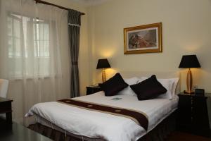Postel nebo postele na pokoji v ubytování Ladoll Service Apartments