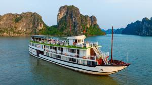 a boat in the water with people on it at Sunlight Legend Cruise in Ha Long +13 photos
