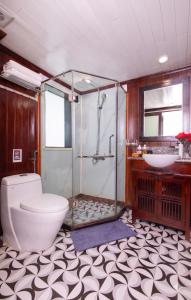 a bathroom with a shower and a toilet and a sink at Sunlight Legend Cruise in Ha Long