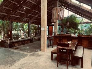 a dining room with a table and a chair at Lexias Hostel and Workspace - Siargao in Catagnan