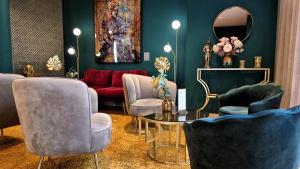 a living room with chairs and a table and a mirror at Boutique-Hotel Amalienhof in Weimar +97 photos