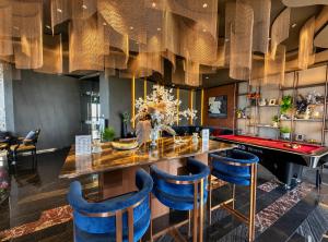 a dining room with a table and blue chairs at The Edge central pattaya in Pattaya