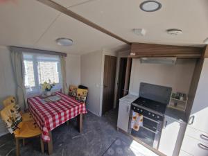 an overhead view of a kitchen with a table and a stove at Durdlee Door, D27, Main Rd, West Lulworth, Wareham BH20 5PU in West Lulworth