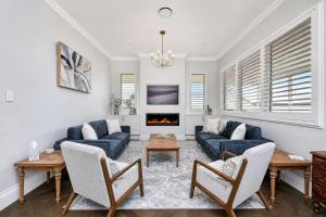 a living room with blue couches and a fireplace at Stellaview Estate in Mitchells Flat