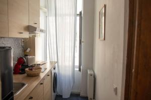 a kitchen with a window with a sink and a counter at Studio Old Town with Jacuzzi and View in Bucharest