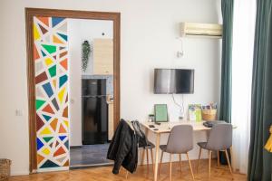 a kitchen with a table and chairs and a refrigerator at Studio Old Town with Jacuzzi and View in Bucharest
