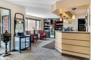 a barber shop with chairs and a counter in a room at Comfort Inn Manistique in Manistique
