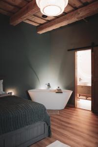a bedroom with a bath tub and a bed and a tub at Apartment No 14 in Līgatne
