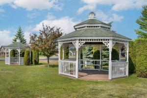 a white gazebo in a park at Quality Inn & Suites Manistique in Manistique