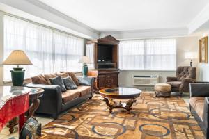 a living room with a couch and a table at Quality Inn & Suites Manistique in Manistique