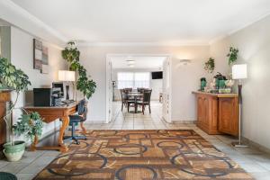 a living room and dining room with a desk and a table at Quality Inn & Suites Manistique in Manistique