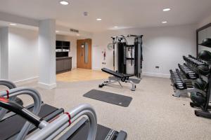a gym with treadmills and machines in a room at Hilton Garden Inn Abingdon Oxford in Abingdon +45 photos