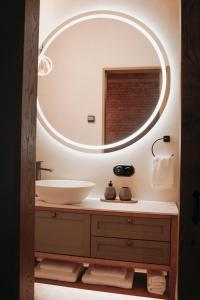 a bathroom with a sink and a large mirror at Apartment No 14 in Līgatne +21 photos