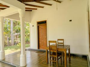 a dining room with a table and two chairs at Randiwa Homestay in Sigiriya