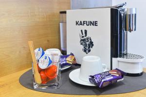 a table with a coffee maker and some food at Villa Rosa in Timişoara