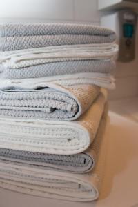 a stack of white towels stacked on top of each other at Lahti Center House in Lahti