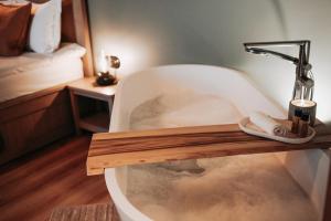 a bath tub with a faucet in a room at Apartment No 14 in Līgatne