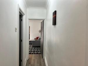 a hallway leading to a living room with a couch at Accessible Flat Bedford in Bedford