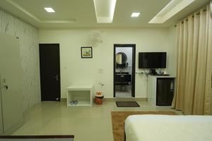 a room with a bed and a tv and a room with at Hotel Quality Inn in Āīzawl +25 photos