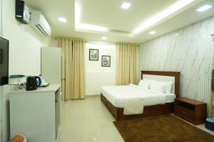 a hotel room with a bed and a refrigerator at Hotel Quality Inn in Āīzawl