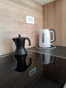 a table with a coffee maker and a coffee pot on it at Apartment MoiRai in Gračišče