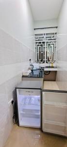 a kitchen with a sink and an open refrigerator at Ligas homes in Dodoma +15 photos