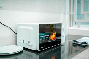 a microwave sitting on a counter with a plate at Ligas homes in Dodoma