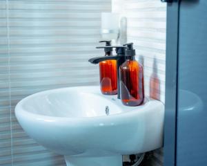 a bathroom sink with two soap dispensers on it at Ligas homes in Dodoma