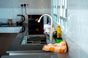 a kitchen sink with a faucet on a counter at Ligas homes in Dodoma