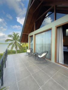 a balcony of a house with a view of the ocean at Moonstone herbal villa in Balapitiya