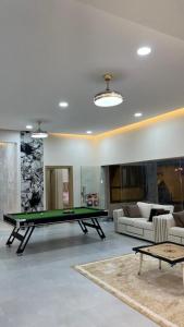 a living room with a pool table in it at استراحه بيت الزلفى in Fulūj Sayghah