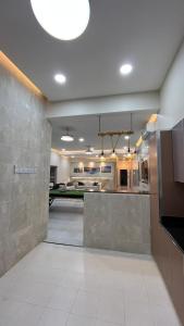 a large kitchen with a counter in a room at استراحه بيت الزلفى in Fulūj Sayghah