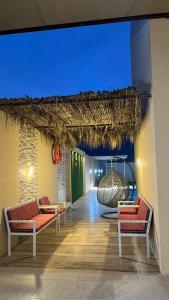 a hallway with chairs and a swing in a building at استراحه بيت الزلفى in Fulūj Sayghah