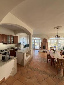 a large kitchen with a table and a dining room at Herczeg Villa in Balatongyörök