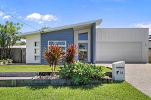 a house with a garden in front of it at Palm Haven Coolum Beach in Coolum Beach