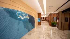 a hallway in a building with a sign on the wall at The Malibu Hotel in Vung Tau +135 photos