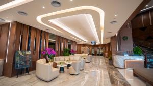 a lobby of a hotel with couches and tables at The Malibu Hotel in Vung Tau