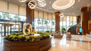a lobby with a large exhibit in the middle of a building at The Malibu Hotel in Vung Tau