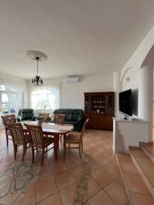 a living room with a table and chairs at Herczeg Villa in Balatongyörök